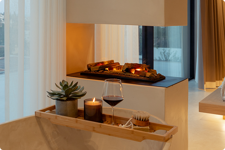 Dimplex hybrid fireplace with decorative log set in a bathroom setting