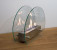 Circular tabletop fireplace wit glass panels on the sides