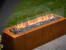 Planika Galio Outdoor gas fireplace in corten steel finish and with manual control system