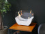 White cradle shaped fireplace with glass panels