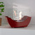 Red cradle shaped fireplace with glass panels